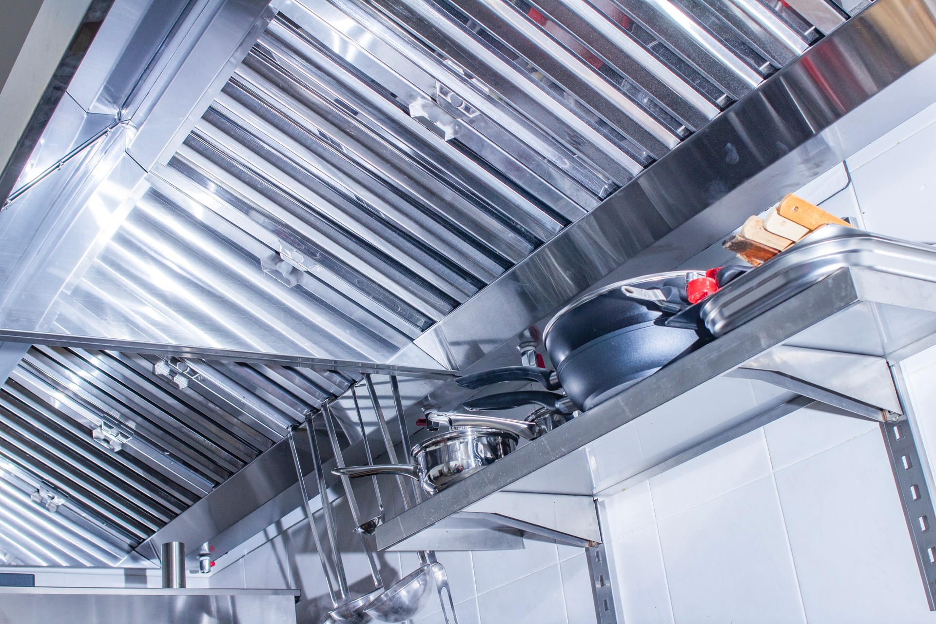 professional hood in a restaurant kitchen made of stainless steel with galvanized duct